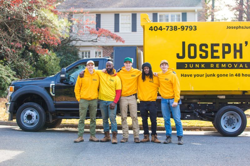 Joseph's Junk Removal group photo in front of their junk truck