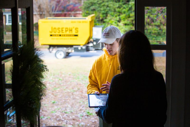 Joseph's Junk Removal going over pricing details before service