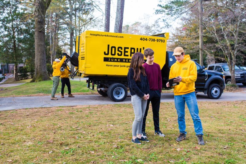 Joseph's Junk Removal worker going over pricing options with customers in Atlanta